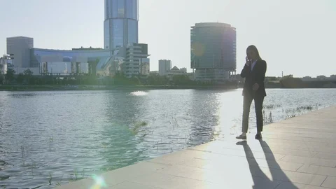Professional consultant having mobile conversation with client outdoors Stock Footage 120666210