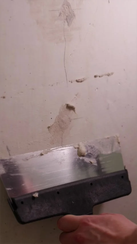 Professional contractor applying spackle compound on drywall Stock Footage 340610716