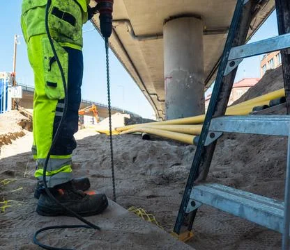 Professional contractor preparing utility infrastructure in summer Stock Photos