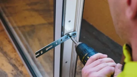 The professional contractor uses a power tool to fasten the window. Stock Footage 264566966