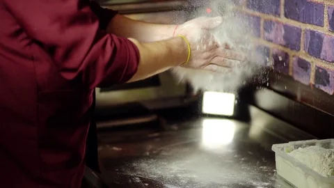 Professional cook claps her hands and powder flies. Video stock 106389209
