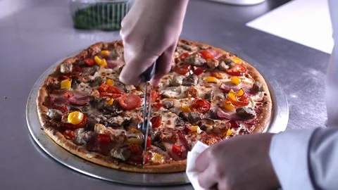 Professional cook cuts the pizza Stock Footage 87641634