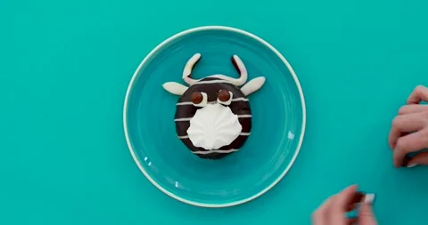 Professional cook hands add sweets on dessert of cow form Video stock 140182587