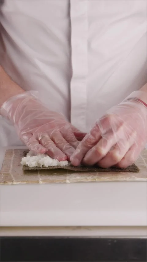 Professional cook kneading and separating sticky sushi rice grains Stock Footage 337119191
