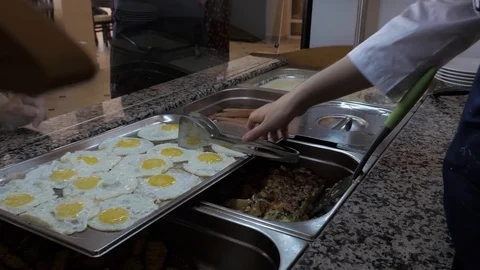 Professional cook takes fried egg and puts on plate in cafe Stock Footage 124024006