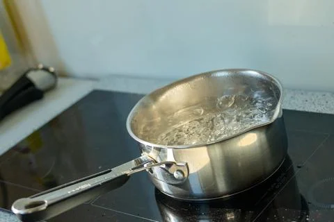 Professional cookware showing active rolling boil with bubbles and steam Stock Photos