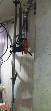 Professional core drilling setup to drill concrete ceiling Stock Photos