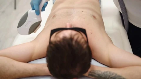 Professional cosmetologist in blue gloves using a laser machine for epilati.. Stock Footage 345235990
