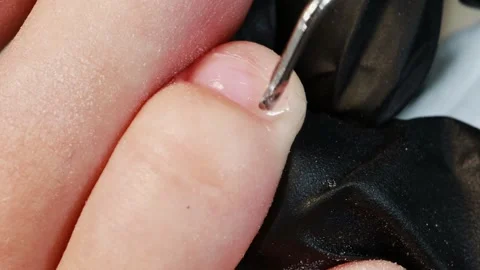 A professional cosmetologist uses instruments to treat a womans nails at a Video stock 329091153