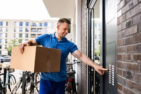 The Professional Courier Utilizing Advanced Intercom System Foto stock