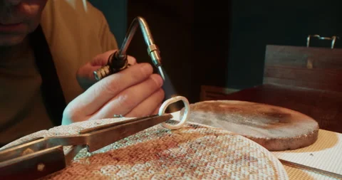 Professional craftsman burning silver ring Stock Footage 265662558