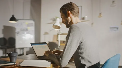 Professional Creative Man Sitting at His Desk in Home Office Working on Laptop Stock Footage 111618374