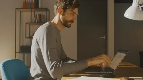 Professional Creative Man Sitting at His Desk in Home Office Working on Laptop Stock Footage 111620806