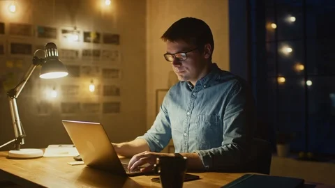 Professional Creative Man Sitting at His Desk in Office Studio Working on Laptop Stock Footage 111629708