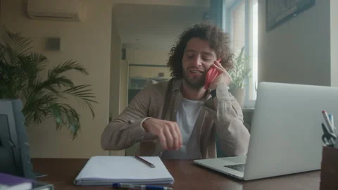 Professional creative man sitting at his desk in home office studio and talking Stock Footage 192049625