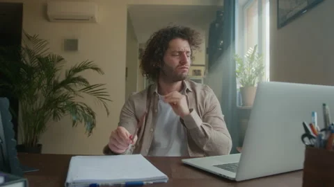 A professional creative man is sitting at his desk in a home office studio, bad Stock Footage 192051045