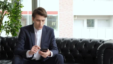 Professional Creative Man Sitting in Home Office Studio Using Smartphone Stock Footage 129637215