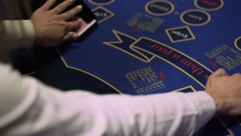 Professional croupier shuffling cards on table in casino, poker game. Close-up Stock Footage 132063399