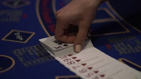 Professional croupier shuffling cards on table in casino, poker game. Close-up Stock Footage 132064904