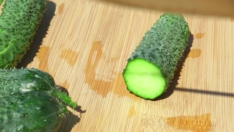 Professional cucumber slicing technique demonstration on cutting board Stock Footage 316329357