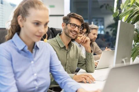 Professional customer support agent man in assisting customers at call center Stock-Fotos