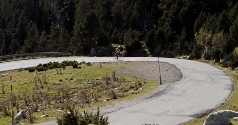 Professional cyclist climbing a mountain during a race Stock Footage 140901926