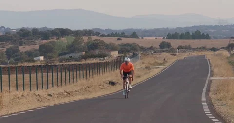 Professional cyclist man training hard on a road for a competition. Stock Footage 231726968