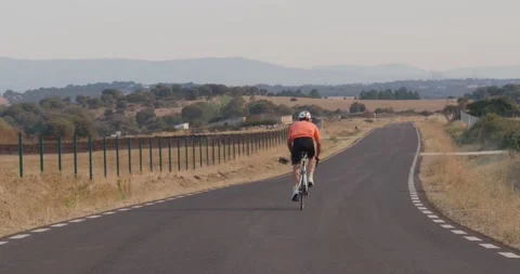 Professional cyclist man training on a road in nature Stock Footage 231726946