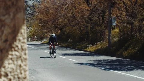 A professional cyclist rides a high-speed bike on the road Stock Footage 223521764