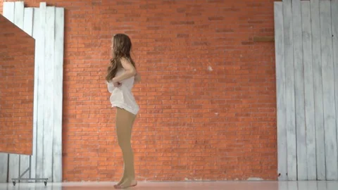 A professional dancer dances in the ballroom in front of a mirror. a woman is Stock Footage 81518271