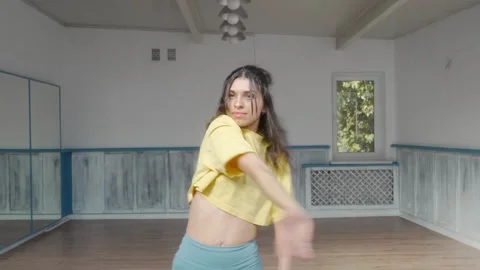 Professional dancer performs fluid spins and expressive movements in a studio. Stock Footage 287099328