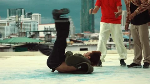 Professional dancer practice B boy dance with friends at roof top. hiphop. Stock Footage 274386217