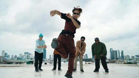 Professional dancer practice B boy dance with friends at roof top. Endeavor. Stock Photos