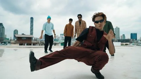 Professional dancer practice B boy dance with friends at roof top. Endeavor. Stock Photos