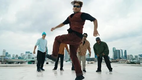 Professional dancer practice B boy dance with friends at roof top. Endeavor. Stock Photos