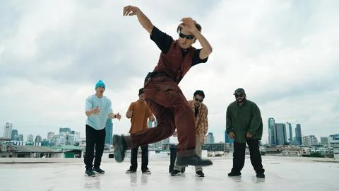 Professional dancer practice B boy dance with friends at roof top. Hiphop. Stock Photos