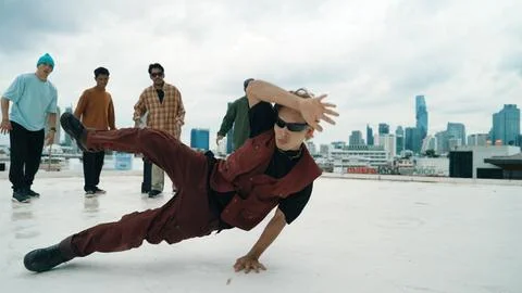 Professional dancer practice B boy dance with friends at roof top. Hiphop. Stock Photos