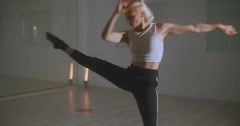 Professional dancer practicing contemporary dance routine in ballet studio Stock Footage 229488221
