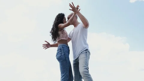 Professional dancers dancing together on sky background Stock Footage 123022406