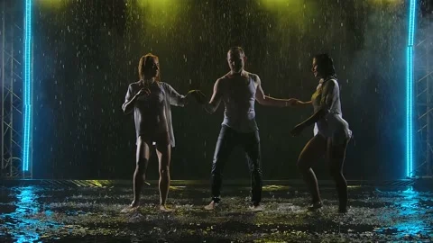 Professional dancers perform salsa elements in a dark smoky studio. Silhouettes Stock Footage 138565931