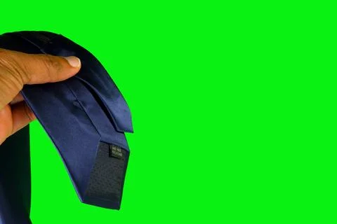 Professional dark skinned hand adjusting a zipper tie on vibrant green screen Stock Photos