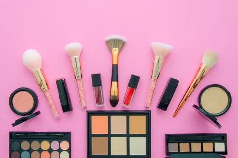 Professional decorative cosmetics, makeup tools on pink background. Flat Stock Photos