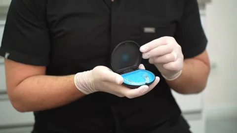 Professional dentist presenting clear aligners orthodontic treatment tool for Stock Footage 245297091