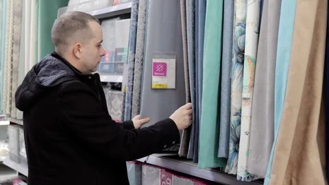 Professional designer selecting colorful fabric swatches, comparing textures and Stock Footage 328020610