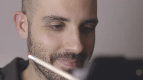 Professional designer thinks, then has an idea for a sketch. Closeup side shot Stock Footage 145128379