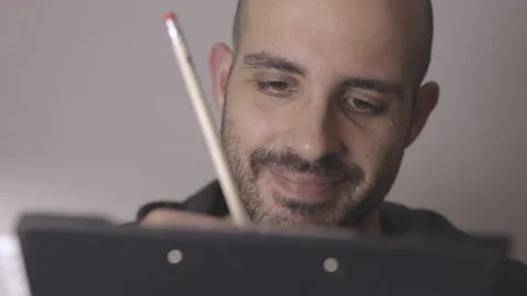 Professional designer thinks, then has an idea for a sketch. Front view Stock Footage 145128434