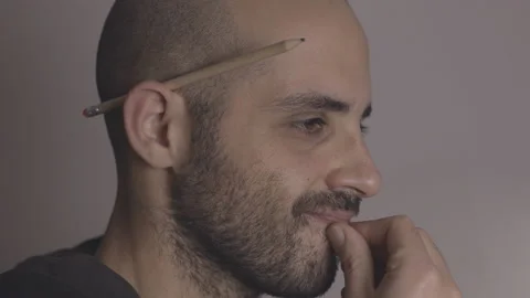 Professional designer thinks, then has an idea for a design work. Sketch concept Stock Footage 145128539