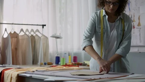 Professional designer transferring pattern samples to fabric, clothes making Stock Footage 84952444