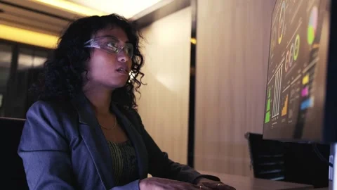 Professional at a desk analyzing interactive data dashboards on a large monitor Stock Footage 319066239