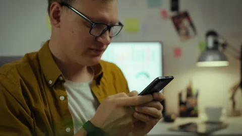 A professional developer makes changes to a program for mobile users while w Stock Footage 281108071